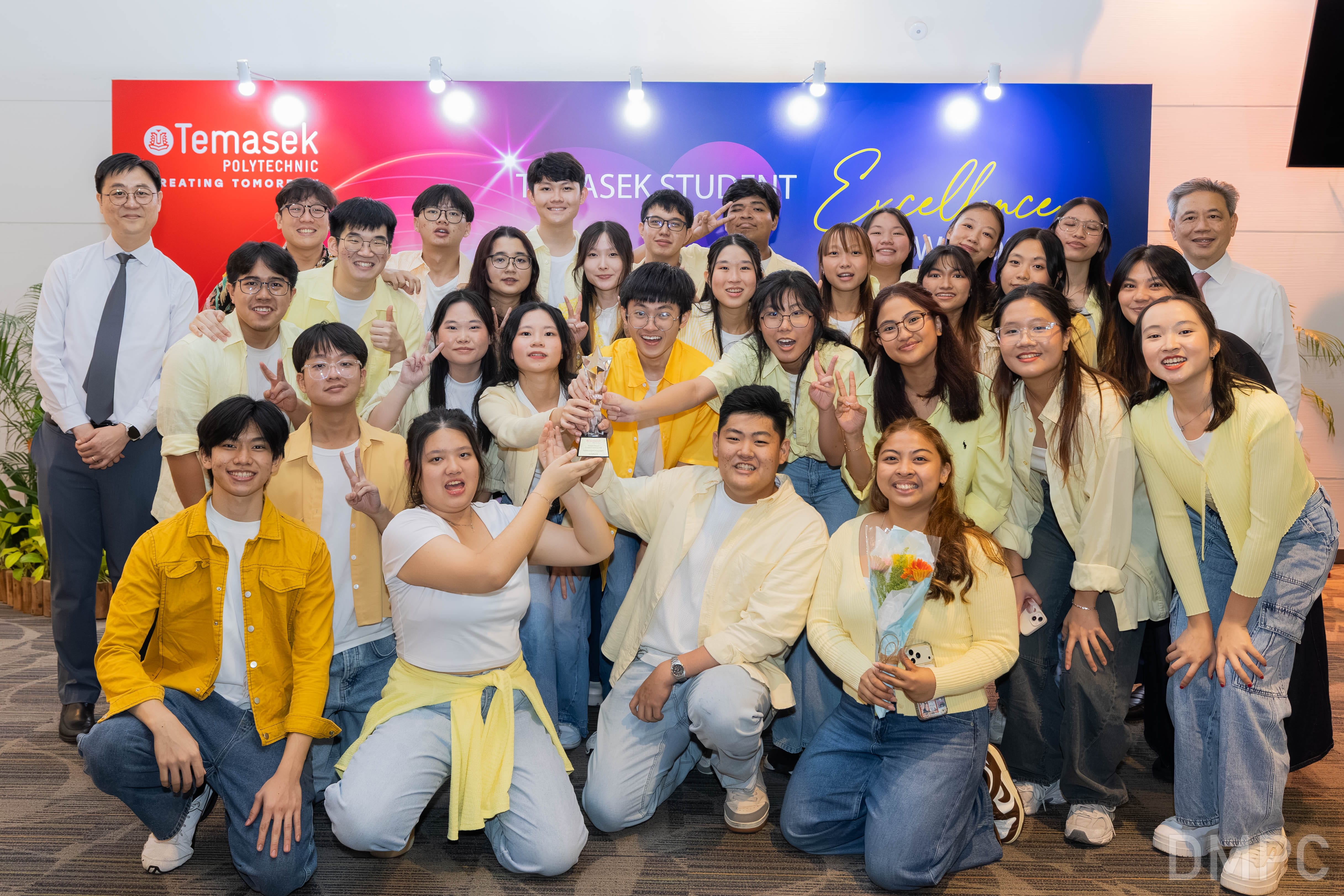 Image of a group of award recipients taking photos with GOH